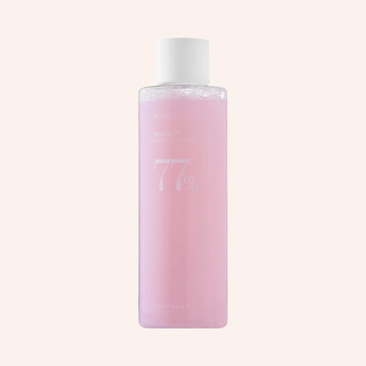 Anua Peach 77% Niacin Essence Toner 250ml – rosafarbene Spenderflasche vor rosa Grund