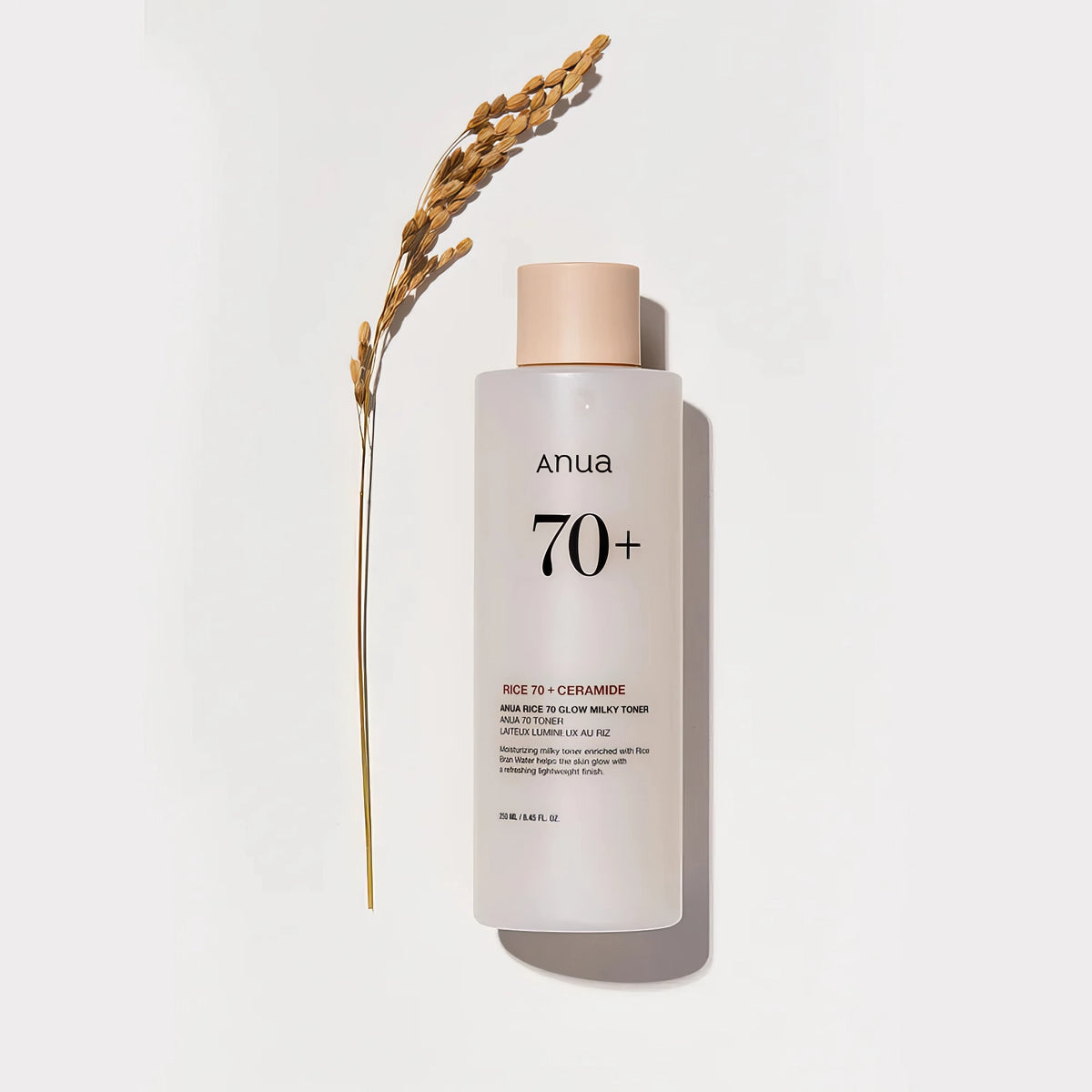 Anua Rice 70 Glow Milky Toner 250ml – weiße Flasche vor goldenen Reis- und Getreidehalmen
