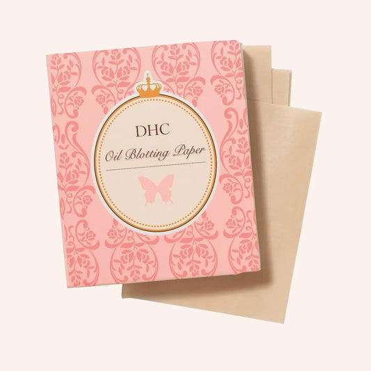 DHC Oil blotting paper 100 Blatt – rosa Packung mit verspieltem Design, flach auf rosa Untergrund