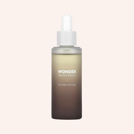 Haruharu Wonder Black Rice Facial Oil 10ml – Pipettenflasche mit hellgelbem Öl vor schwarzem Hintergrund