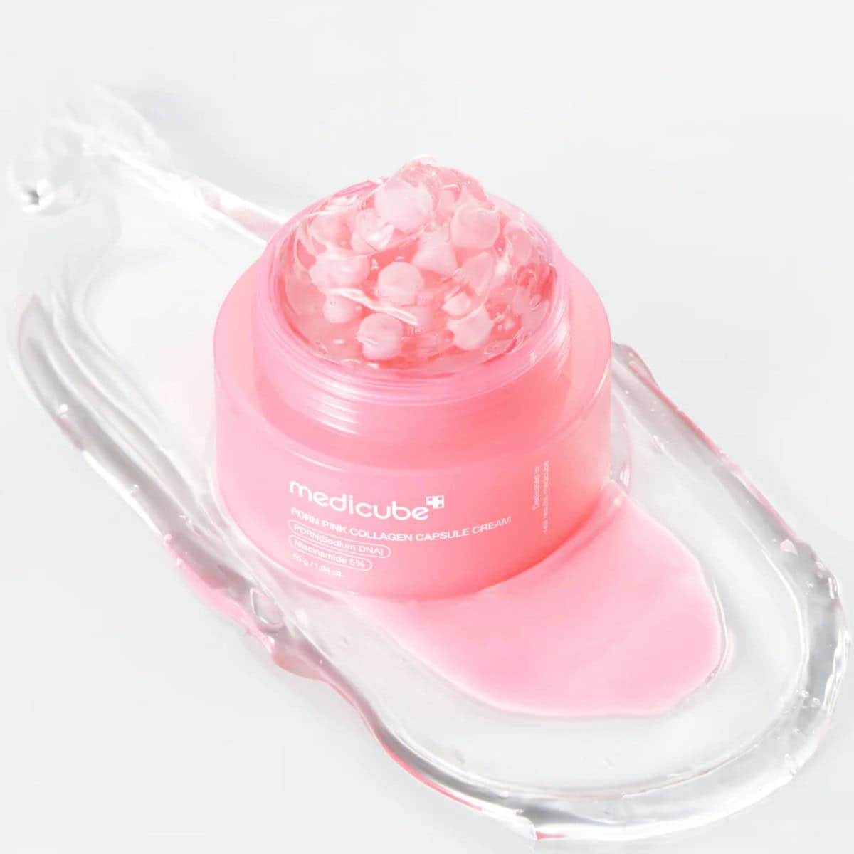 Medicube PDRN Pink Collagen Capsule Cream 55g – rosa Tiegel auf transparentem Tablett, rosa Grund