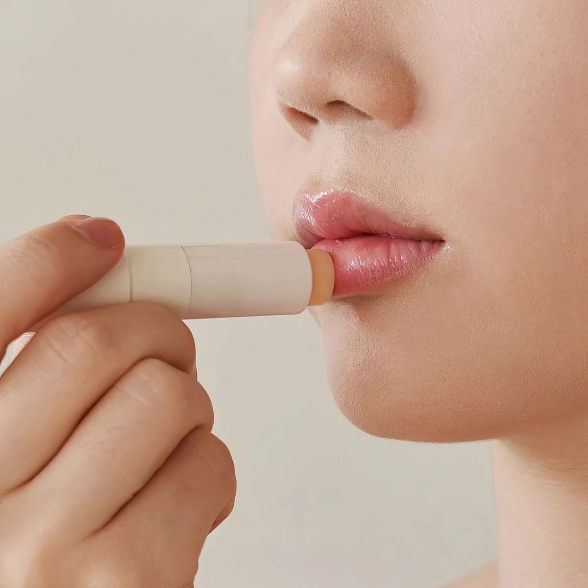 Melixir Vegan Lip Butter #01. Agave – zweigeteiltes Bild: links Lippen beim Auftragen, rechts weiße Tube mit schwarzer Kappe